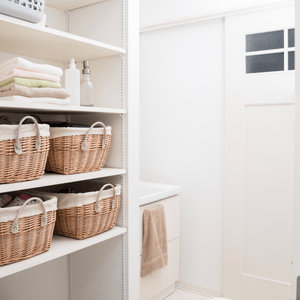 laundry room remodel ideas for storage- baskets on white shelf